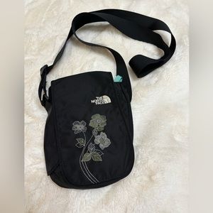 Canvas North Face bag , has wide strap with zipper on one side with pocket